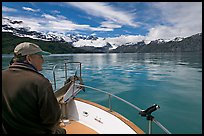 Man sitting at the bow of a small boat. Glacier Bay National Park, Alaska, USA.