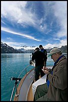 Movie producer taking notes as crew films. Glacier Bay National Park, Alaska, USA. (color)
