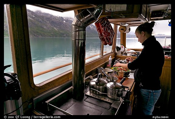 Chef preparing sadad in the main cabin of the Kahsteen. Glacier Bay National Park, Alaska, USA.