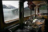 Breakfast potatoes in a small boat moored in front of glacier. Glacier Bay National Park, Alaska, USA. (color)