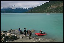 Film crew met by a skiff after shore excursion. Glacier Bay National Park, Alaska, USA. (color)