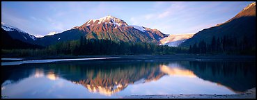 Mountains and glacier reflected in Resurrection River. Kenai Fjords National Park, Alaska, USA.