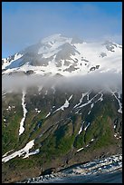 Glacier, and cloud hanging at mid-height of peak. Kenai Fjords National Park, Alaska, USA.