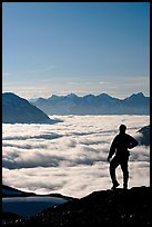 Man above a sea of clouds. Kenai Fjords National Park, Alaska, USA. (color)