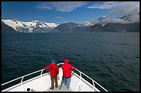 Passengers with red jackets on bow of tour boat, Northwestern Fjord. Kenai Fjords National Park, Alaska, USA. (color)