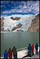 People watch  Northwestern glacier from deck of boat, Northwestern Lagoon. Kenai Fjords National Park, Alaska, USA.