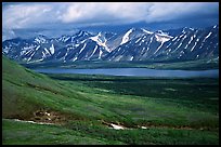 Verdant tundra, lake, and snowy mountains under clouds. Lake Clark National Park, Alaska, USA. (color)