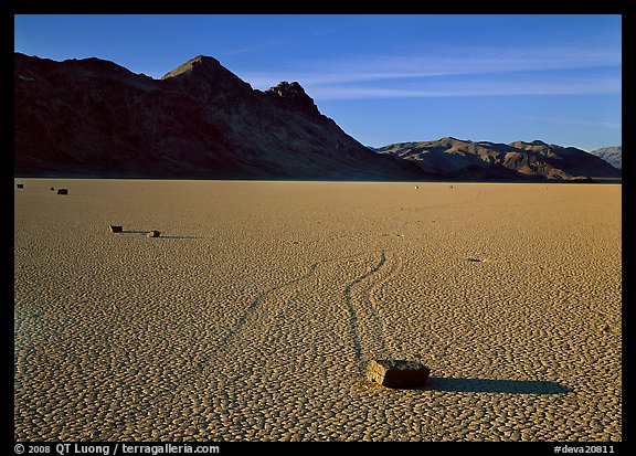Tracks, moving stone on Racetrack playa and Ubehebe Peak, late afternoon. Death Valley National Park, California, USA.