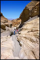 Hikers in narrows, Mosaic canyon. Death Valley National Park, California, USA.