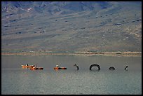Kayakers approaching the dragon in the rare Manly Lake. Death Valley National Park ( color)