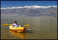 Kayaker padding ephemeral Manly Lake. Death Valley National Park, California, USA.