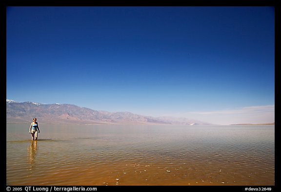 Woman wading in Manly Lake. Death Valley National Park, California, USA.