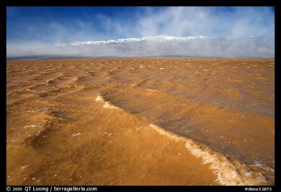 Extremely rare waves on mud-colored Manly Lake, early morning. Death Valley National Park, California, USA.