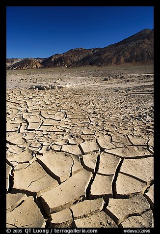 Mud cracks and Funeral mountains. Death Valley National Park, California, USA.