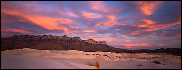 White sand dunes, mountain range, and colorful clouds. Guadalupe Mountains National Park, Texas, USA.