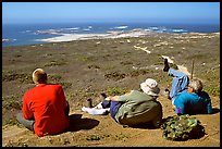 Hikers observing Point Bennett from a distance, San Miguel Island. Channel Islands National Park, California, USA. (color)