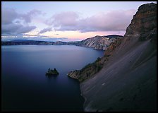 Caldera slopes and Phantom ship at dusk. Crater Lake National Park, Oregon, USA.