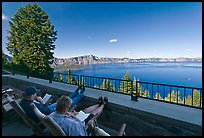Reading on Crater Lake Lodge Terrace overlooking  Lake. Crater Lake National Park, Oregon, USA.