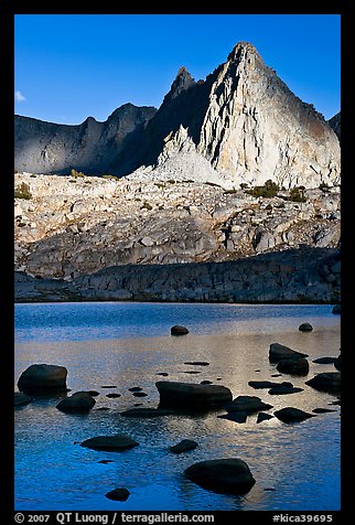 Isocele Peak reflected in lake, late afternoon, Dusy Basin. Kings Canyon National Park, California, USA.