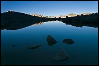Rocks and calm lake with reflections, early morning, Dusy Basin. Kings Canyon National Park, California, USA. (color)