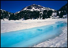 Turquoise melting snow in lake Helen and Lassen Peak, late spring. Lassen Volcanic National Park, California, USA. (color)