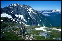 Mountaineer hiking on the way to Sahale Peak,  North Cascades National Park. Washington, USA. (color)