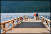 Couple on Pier, Crescent Lake. Olympic National Park, Washington, USA. (color)