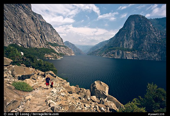 Father hiking with boy next to Hetch Hetchy reservoir. Yosemite National Park, California, USA.