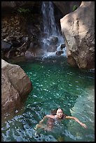Girl swims in cool pool at the base of Wapama falls. Yosemite National Park ( color)