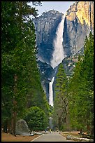 Tourists on path dwarfed by Upper and Lower Yosemite Falls. Yosemite National Park, California, USA.