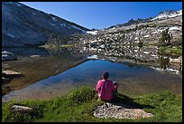 Hiker sitting by alpine lake, Vogelsang. Yosemite National Park ( color)