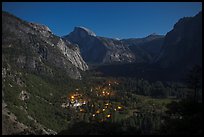 Yosemite Village lights and Half-Dome by moonlight. Yosemite National Park, California, USA.