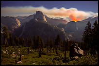 Half-Dome and plume of smoke from wildfire at night. Yosemite National Park, California, USA.