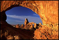 Turret Arch seen through South Window, sunrise. Arches National Park, Utah, USA.