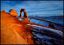 Sandstone bowl, Delicate Arch, and La Sal Mountains with snow, sunset. Arches National Park, Utah, USA.