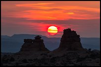 Sun setting between rock towers. Arches National Park, Utah, USA. (color)
