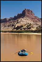 Woman paddling raft on Colorado River. Canyonlands National Park, Utah, USA.