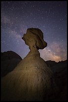 Balanced rock at night with starry sky and Milky Way. Badlands National Park, South Dakota, USA. (color)