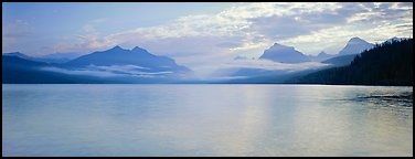 Serene lake with clouds hanging over mountains. Glacier National Park, Montana, USA.