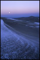 Dunes at dawn with snow and moon. Great Sand Dunes National Park and Preserve, Colorado, USA.