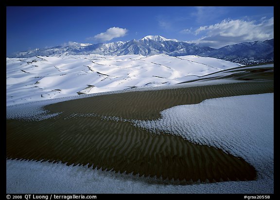 Patch of sand, snow-covered dunes, Sangre de Christo mountains. Great Sand Dunes National Park and Preserve (color)