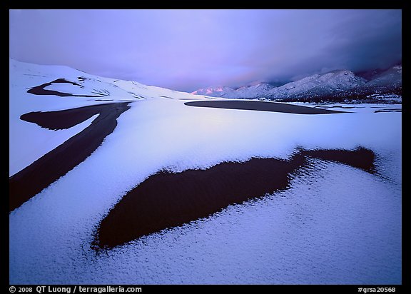 Patch of sand in snow-covered dunes. Great Sand Dunes National Park and Preserve (color)