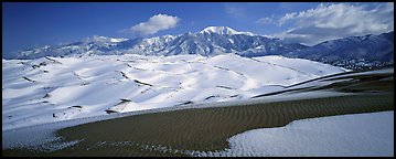 Landscape of snowy dunes and mountains. Great Sand Dunes National Park (Panoramic color)