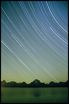Star trails on Teton range above Jackson lake, dusk. Grand Teton National Park, Wyoming, USA. (color)