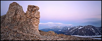 Rock towers on high pass and mountains at dusk. Rocky Mountain National Park, Colorado, USA.