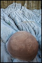 Spherical cannonball concretion in badlands. Theodore Roosevelt National Park, North Dakota, USA. (color)