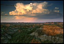 Storm cloud and badlands at sunset, South Unit. Theodore Roosevelt National Park, North Dakota, USA. (color)