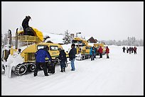 Bombardier snow busses being unloaded at Flagg Ranch. Yellowstone National Park, Wyoming, USA. (color)