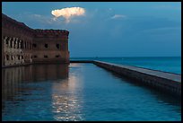 Moat, fort, bright cloud at dawn. Dry Tortugas National Park ( color)
