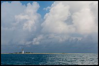 Loggerhead key and lighthouse under tropical clouds. Dry Tortugas National Park, Florida, USA.